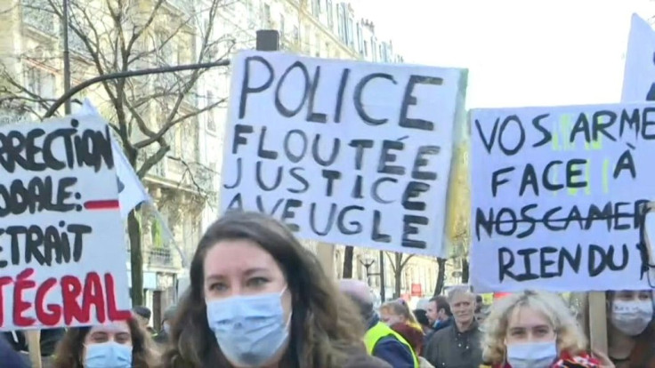 People protest against a proposed French security law that would curb filming of police actions