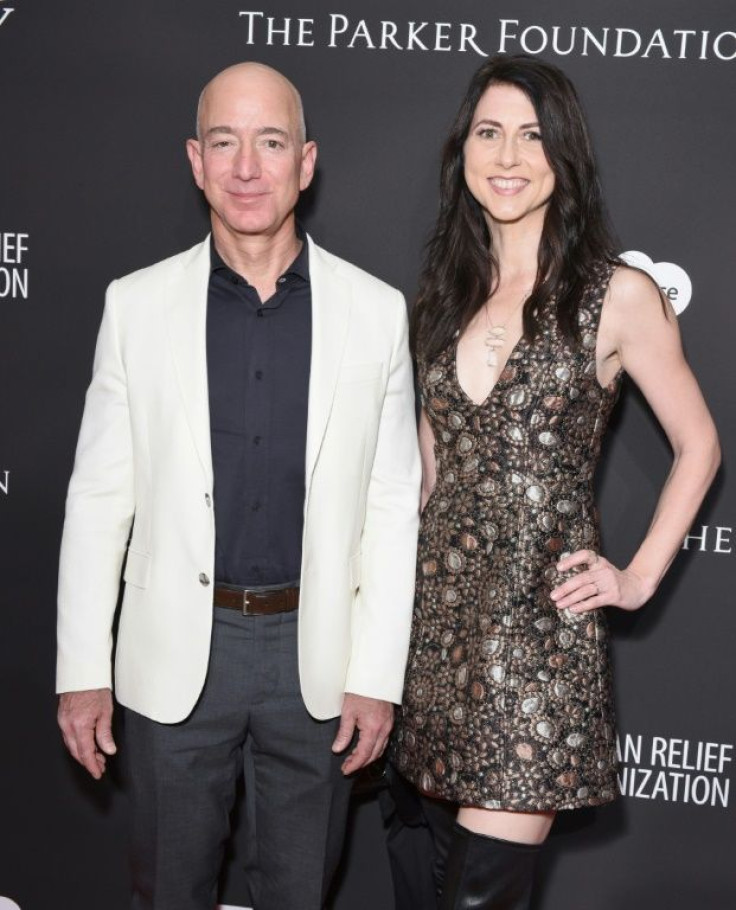 MacKenzie Scott, seen in a 2018 picture before  her divorce with then-husband Jeff Bezos, acquired 25 percent of his stake in Amazon and has set an example for charitable giving that could put pressure on the tech executive to keep pace