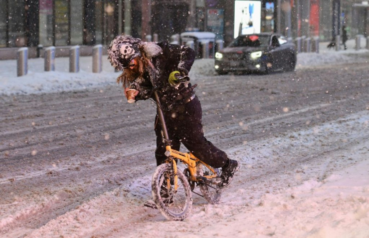 A cyclist struggles through snow in New York on February 1, 2021