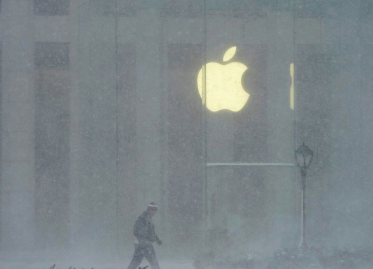 A person walks past the Apple Store on 5th Avenue during a winter storm on February 1, 2021 in New York City
