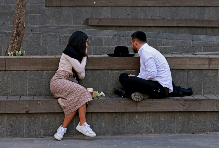 The rituals of pre-marriage courtship for ultra-Orthodox Jews are strictly codified; in this photograph an ultra-Orthodox man and a woman chat outside in a plaza in Jerusalem