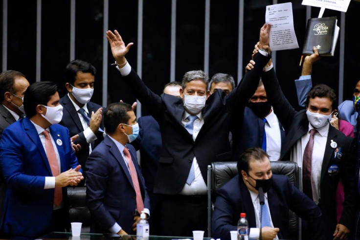 Brazilian Deputy Arthur Lira (C) celebrates after being elected as president of Brazil's Lower House in Brasilia on February 1, 2021