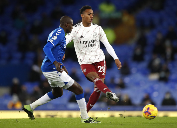  Joe Willock of Arsenal is challenged by Abdoulaye Doucoure of Everton 