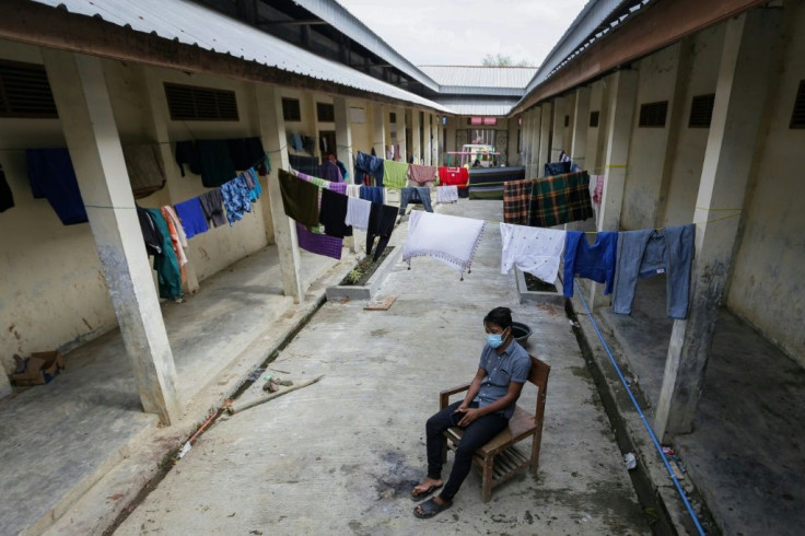 This picture taken on January 30, 2021 shows a Rohingya refugee sitting at the makeshift camp in Lhokseumawe, Indonesia, where only just over 100 refugees remain well down from the almost 400 who arrived in separate boat landings in 2020