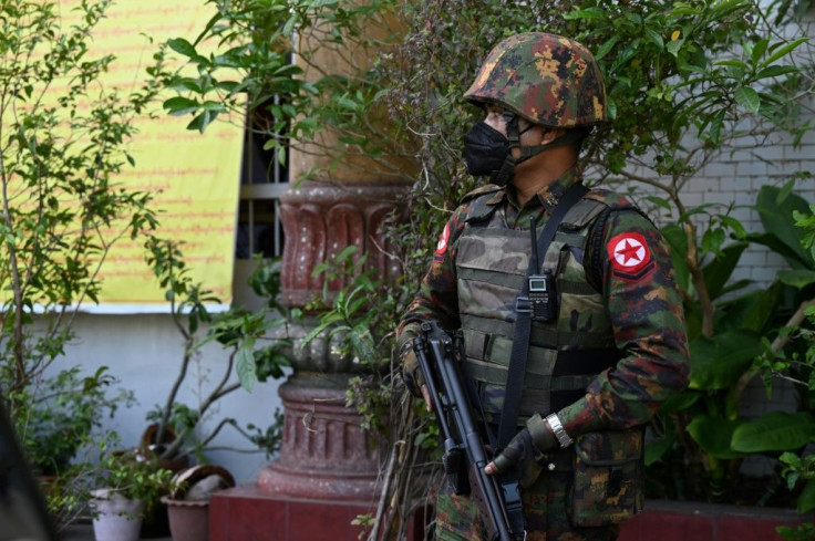 A soldier stands guard as troops arrive at a Hindu temple in Yangon on February 2, 2021, as Myanmar's generals appeared in firm control a day after a surgical coup that saw democracy heroine Aung San Suu Kyi detained