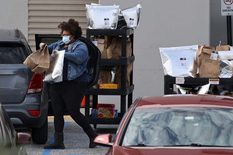 An Amazon Flex driver is seen loading packages outside an Amazon fulfillment center in Baltimore, Maryland in April 2020