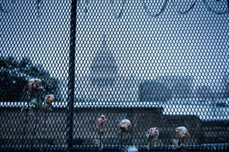 In the aftermath of the deadly US Capitol riot on January 6, 2021, the building remains ringed by a security perimeter, with extra law enforcement and military personnel on guard