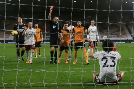 Down and off: David Luiz's (bottom, right) sending off changed the game as Arsenal lost 2-1 to Wolves