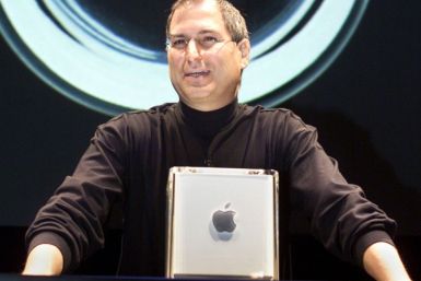 Apple Computer Inc. founder Steve Jobs poses with the company's new Power Mac G4 Cube in 2000