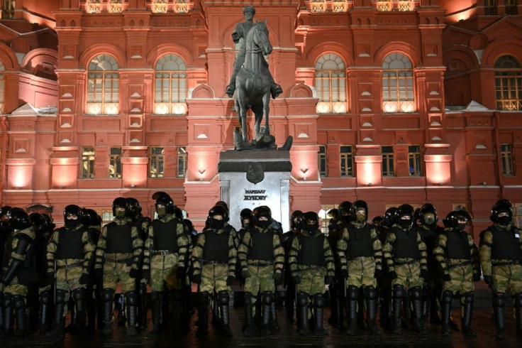 Law enforcement officers stand guard in front of a monument to Soviet Marshal Georgy Zhukov outside Red Square in Moscow following the jailing of Kremlin critic Alexei Navalny