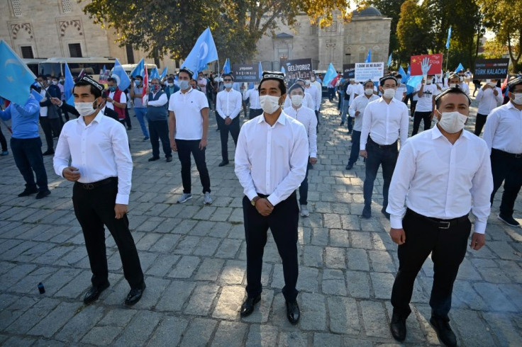 Members of China's Muslim Uighur minority who live outside China, like these protesting in Istanbul, are targets of systematic harassment, rendition and extradition efforts by Beijing, according to a Freedom House report