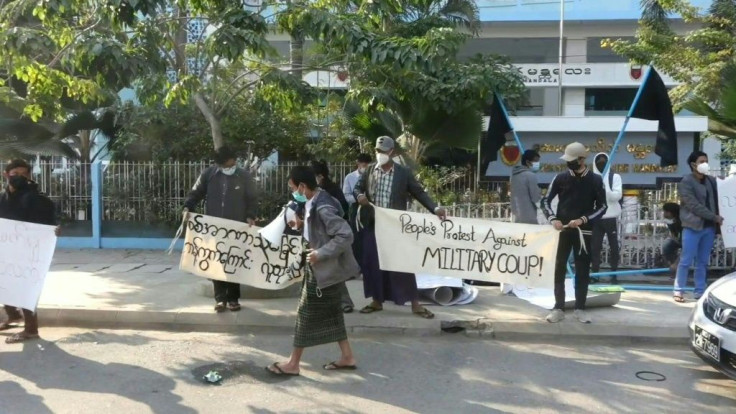 A dozen students and activists with black flags and English-language banners reading âpeopleâs protest against military coup!â voice their anger in the Myanmar city of Mandalay after Mondayâs seizure of power.