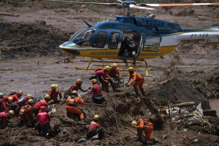 Firefighters search for victims of the 2019 dam collapse at an iron-ore mine belonging to Brazil's giant mining company Vale -- which has agreed to pay $7 billion in damages