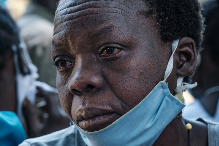 Tears: A woman in Lukodi weeps as she listens to the Dominic Ongwen verdict on the radio