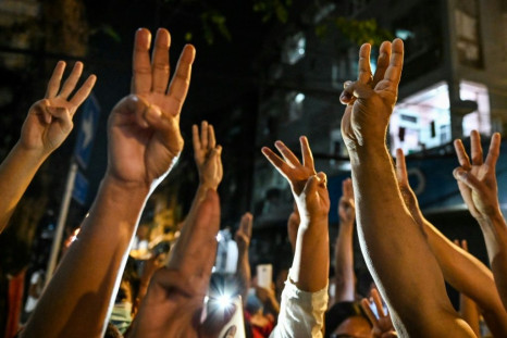 People give a three-finger salute in Myanmar as they protest against a military coup that was been denounced by the UN