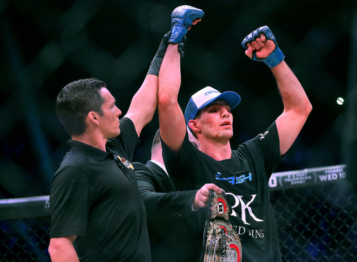 Referee Jason Herzog raises the hand of the new Welterweight World Champion Rory MacDonald after defeating Douglas Lima (red gloves) at Bellator 192 at The Forum 