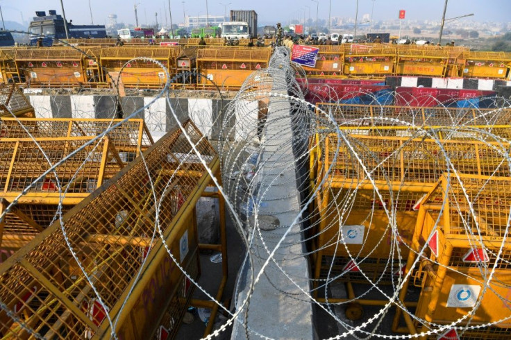 Security personnel stood guard next to police barricades as at the Delhi-Uttar Pradesh state border in Ghaziabad