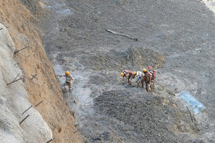 Indo Tibetan Border Police personnel moved to clear Tapovan tunnel from debris following floods after glacier broke off in Chamoli district