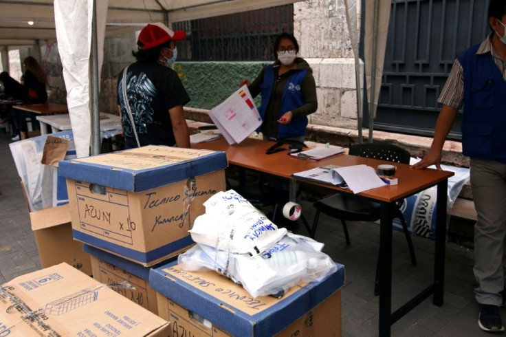 Ecuadorian electoral workers organize the materials for the upcoming general elections at the National Electoral Council of Azuay, in Cuenca, Ecuador