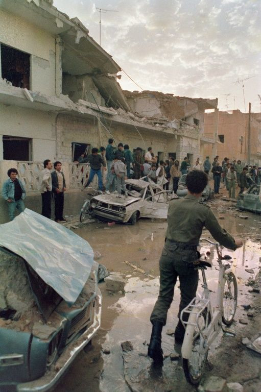 People look at the damage caused by US bombs in Tripoli on April 19, 1986 after a US air raid in retaliation for alleged Libyan terrorist attacks on American targets