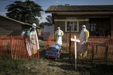 DR Congo medical workers disinfect the coffin an Ebola victim in 2018 -- the government announced the disease has returned
