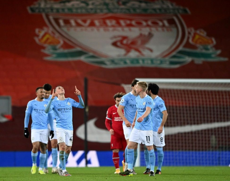 Phil Foden celebrates scoring at Anfield