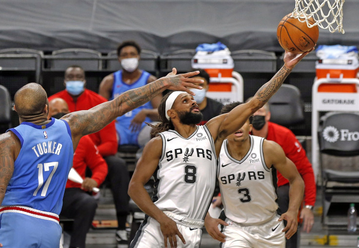 Patty Mills #8 of the San Antonio Spurs stretches to the basket past PJ Tucker #17 of the Houston Rockets