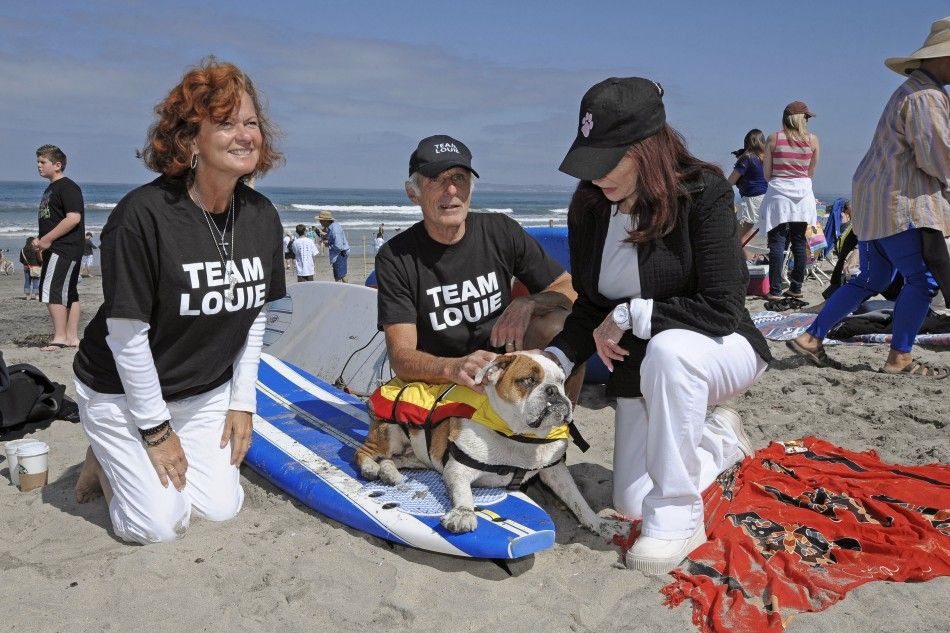 Owners of old British bulldog Louie sit with him before the Loews Surf Dog Competition in Imperial Beach