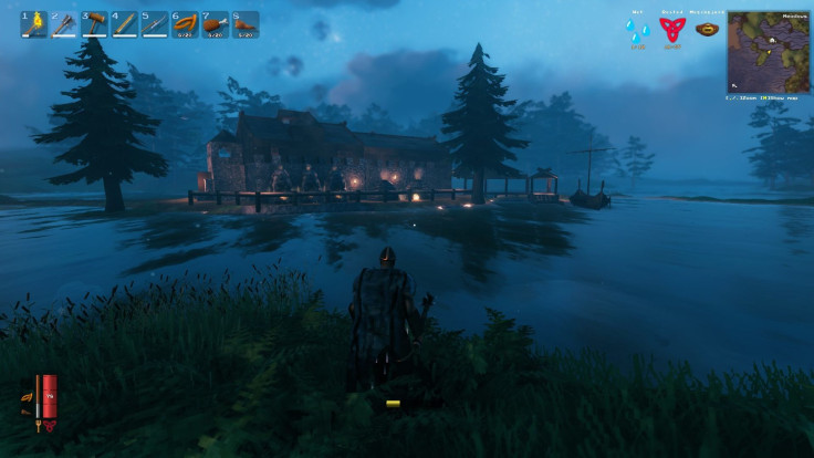 A Valheim player overlooks a fortified base in the middle of a lake