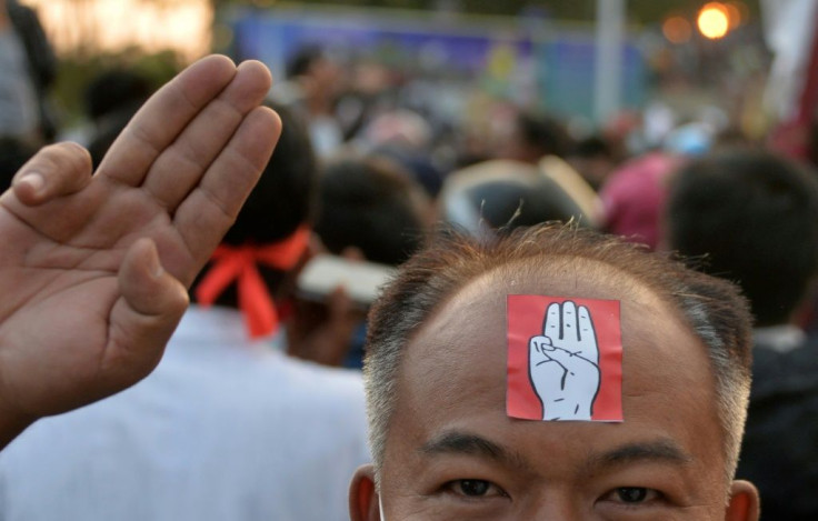 A protester holds up the three finger salute during a demostration against the military coup in Naypyidaw on February 8