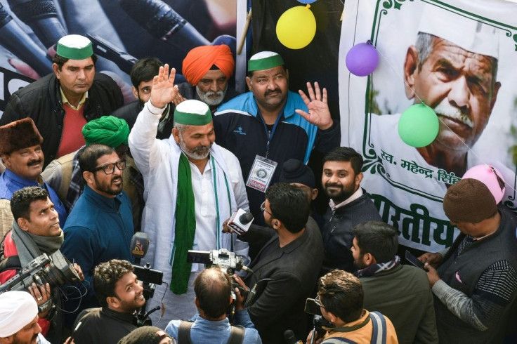 Rakesh Tikait (C, in white) comes from a family that has long been a thorn in the side of India's governments, and now he's refused an order to vacate a protest camp