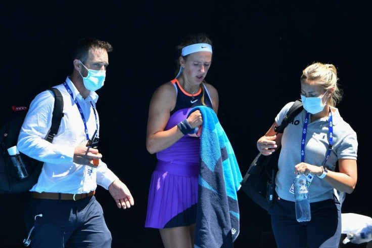 Victoria Azarenka leaves with the doctor (left) to receive medical attention during her defeat to Jessica Pegula