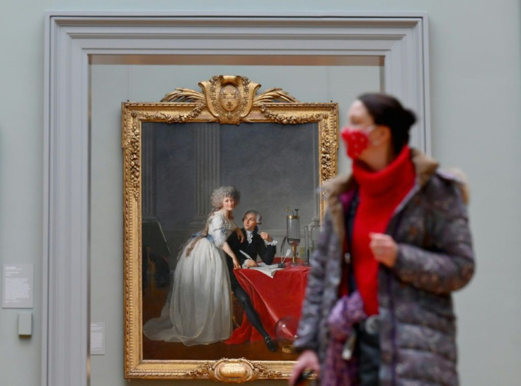 A visitor wearing a facemask looks at paintings at The Metropolitan Museum of Art, 'The Met' in New York City on February 9, 2021