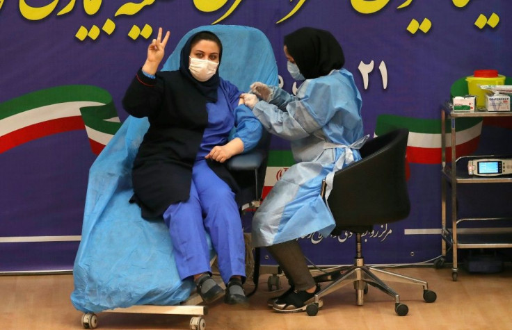 Iranian health worker Sara Gudarzi receives the COVID-19 vaccine as the country launches its inoculation campaign