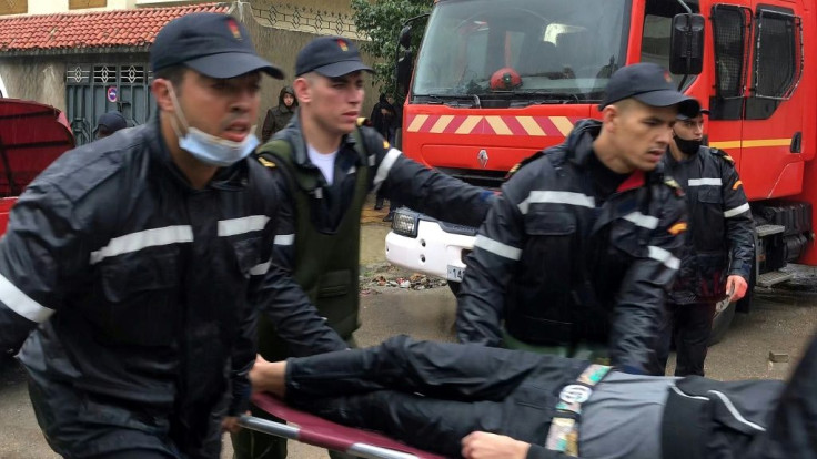 Emergency services carry a man on a stretcher outside the workshop  in  Tangiers