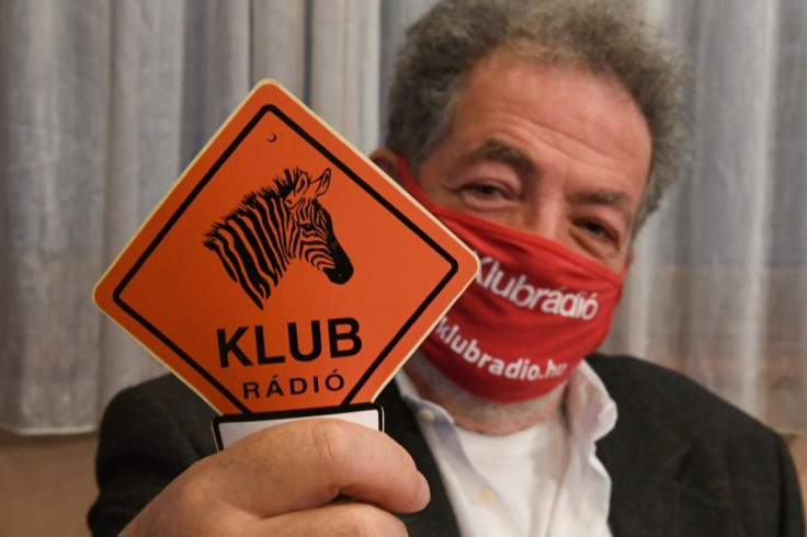 Andras Arato, chairman of the independent Hungarian radio station Klubradio, shows its logo as it loses an appeal to stay on the air