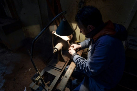 Anis Bouchnak carves a wood pipe at his workshop in the Tunisian coastal town of Tabarka,  a craft passed down by his grandfather and father