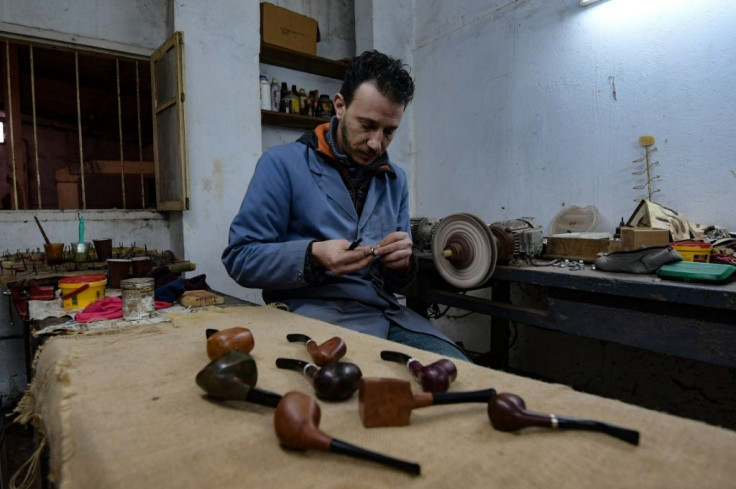 Anis Bouchnak and some of the wood pipes he has carved; the Bouchnak family workshop was established half a century ago