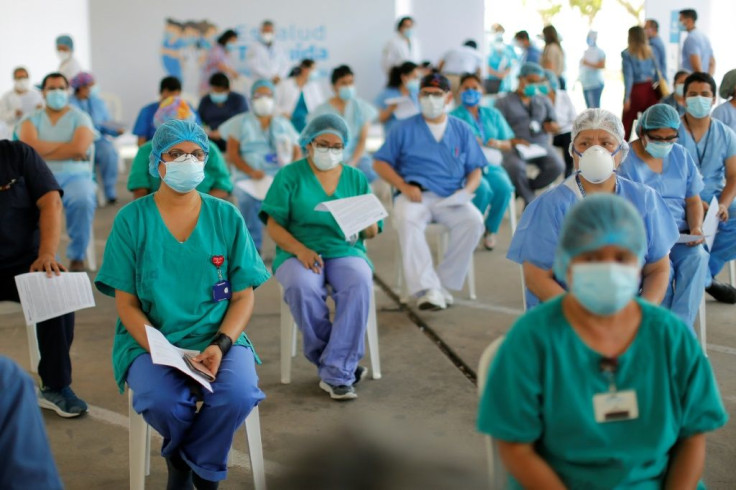 Peruvian health care workers queue to receive the first dose of the Covid-19 vaccine against COVID-19 in Lima