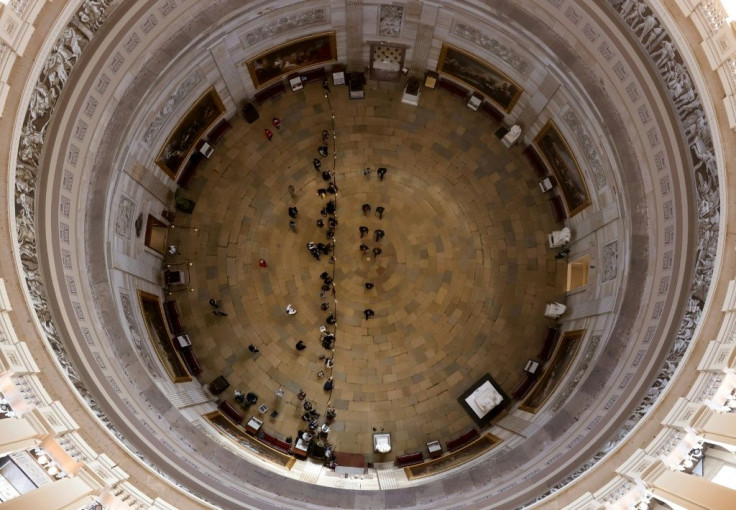 House impeachment managers walk through the Rotunda in the Capitol on Tuesday