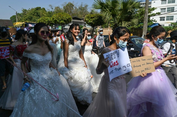 Women wore wedding gowns and displayed jokes about husbands