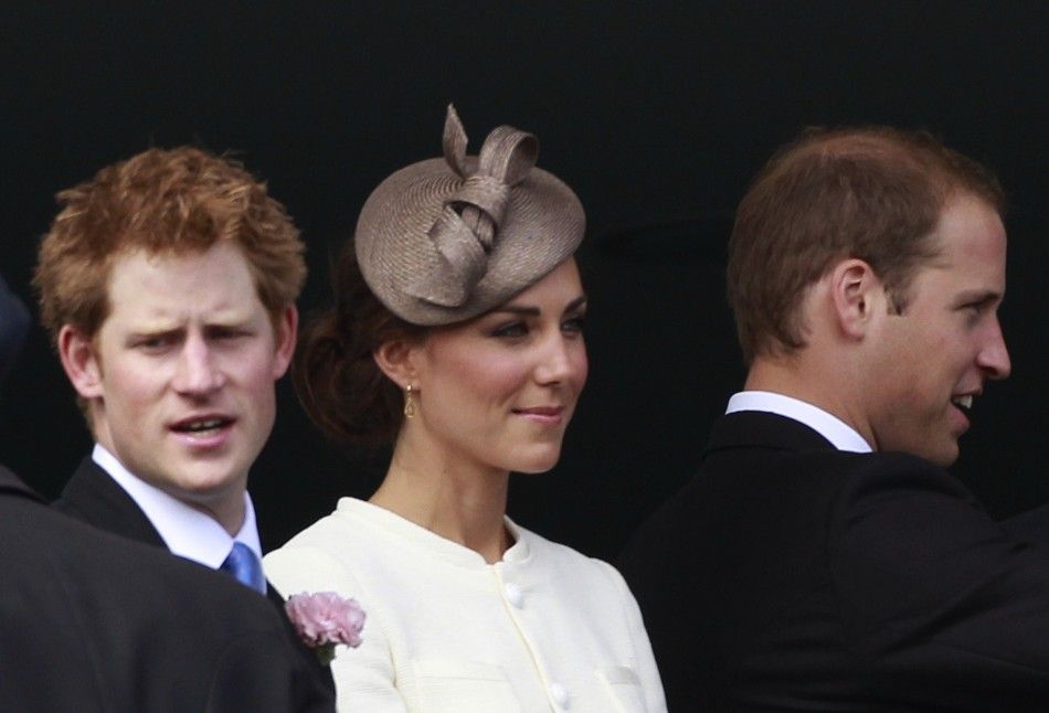 Britain039s Prince Harry, Catherine the Duchess of Cambridge, and Prince William stand on the balcony of the Royal box before the Derby at Epsom Racecourse in southern England