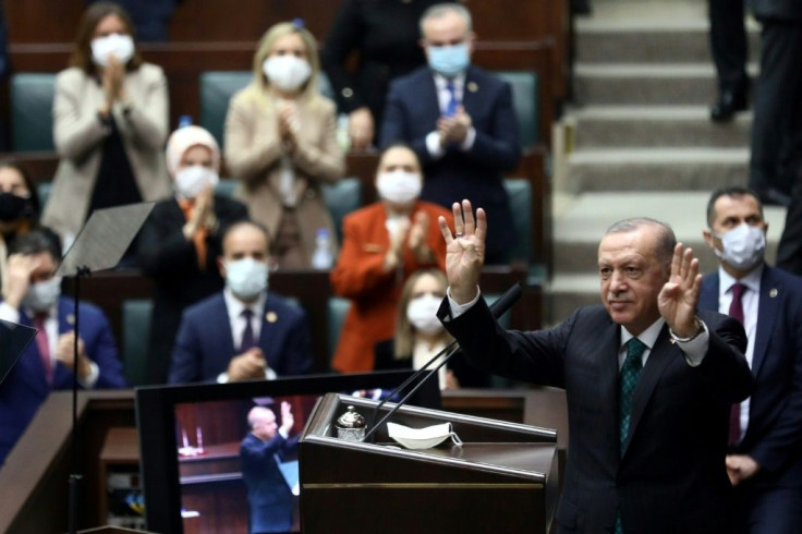 The government of Turkish President Recep Tayyip Erdogan, seen waving to MPs from his AKP party, has sought a compromise with the United States after the purchase of an advanced Russian missile system drew US sanctions