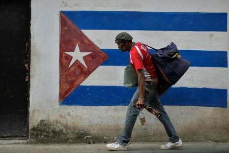A man walks next to a mural of the Cuban flag in Havana in January 2021
