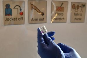 A health worker prepares a dose of the AstraZeneca/Oxford Covid-19 vaccine at a temporary vaccine centre
