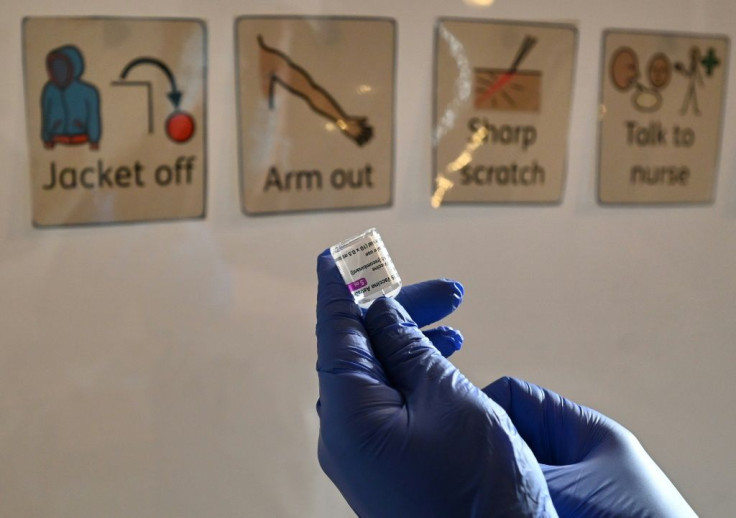 A health worker prepares a dose of the AstraZeneca/Oxford Covid-19 vaccine at a temporary vaccine centre