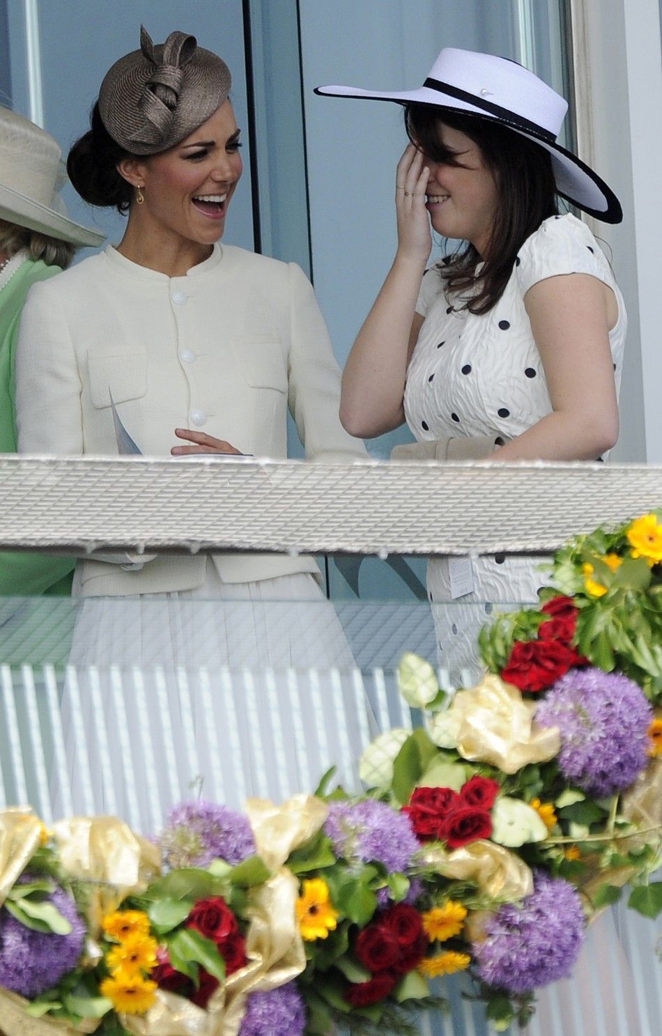 Catherine, Britains Duchess of Cambridge, jokes with Princess Eugenie as they attend Epsom Derby horse race at Epsom Racecourse in southern England