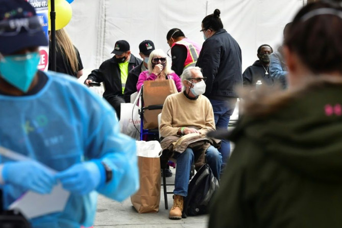 Vaccinated seniors are seated in a waiting area before departure during a distribution of Covid-19 vaccines to seniors above the age of 65 who are experiencing homelessness in Los Angeles