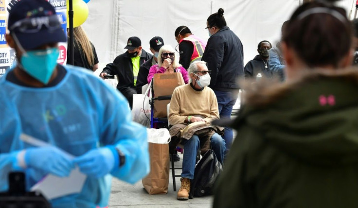 Vaccinated seniors are seated in a waiting area before departure during a distribution of Covid-19 vaccines to seniors above the age of 65 who are experiencing homelessness in Los Angeles