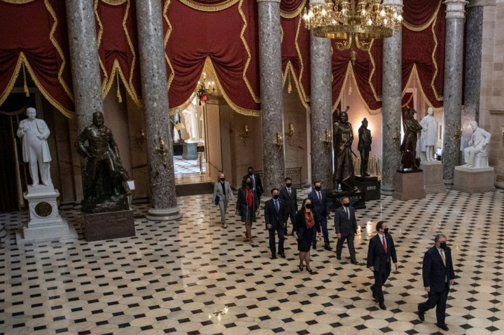 The House impeachment managers, pictured crossing the Capitol Rotunda on February 9, 2021, set up video screens and audio equipment in the Senate to show the graphic imagery and sounds of the deadly chaos from the January 6 attack on the US Capitol